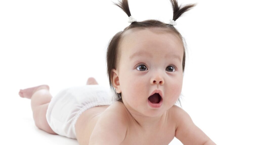 baby on the floor wearing a cloth diaper 