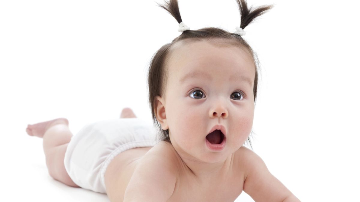 baby on the floor wearing a cloth diaper