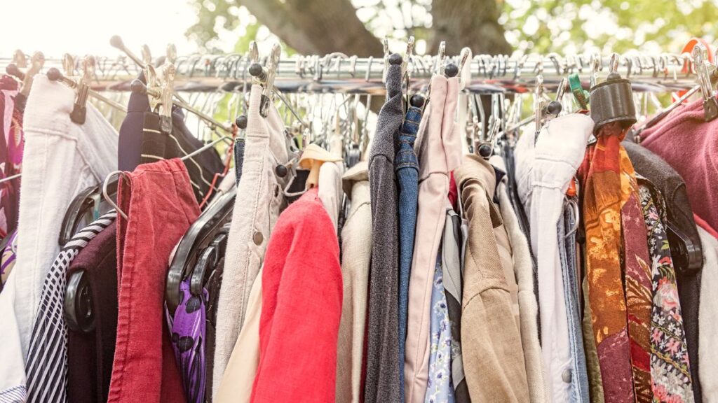 rack of clothes at a flea market