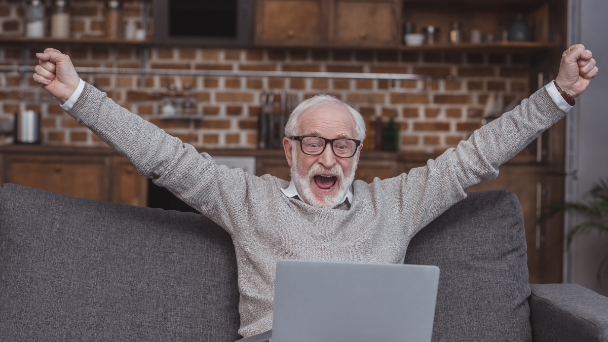 old man excited on computer