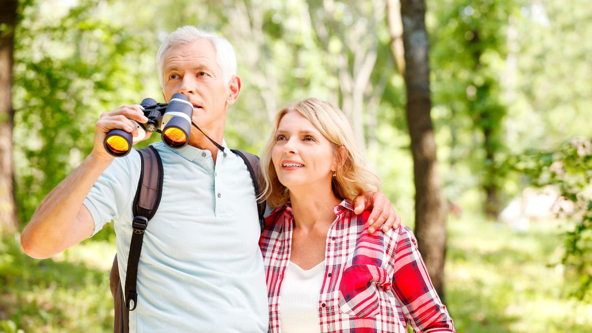 retired couple looking through binoculars