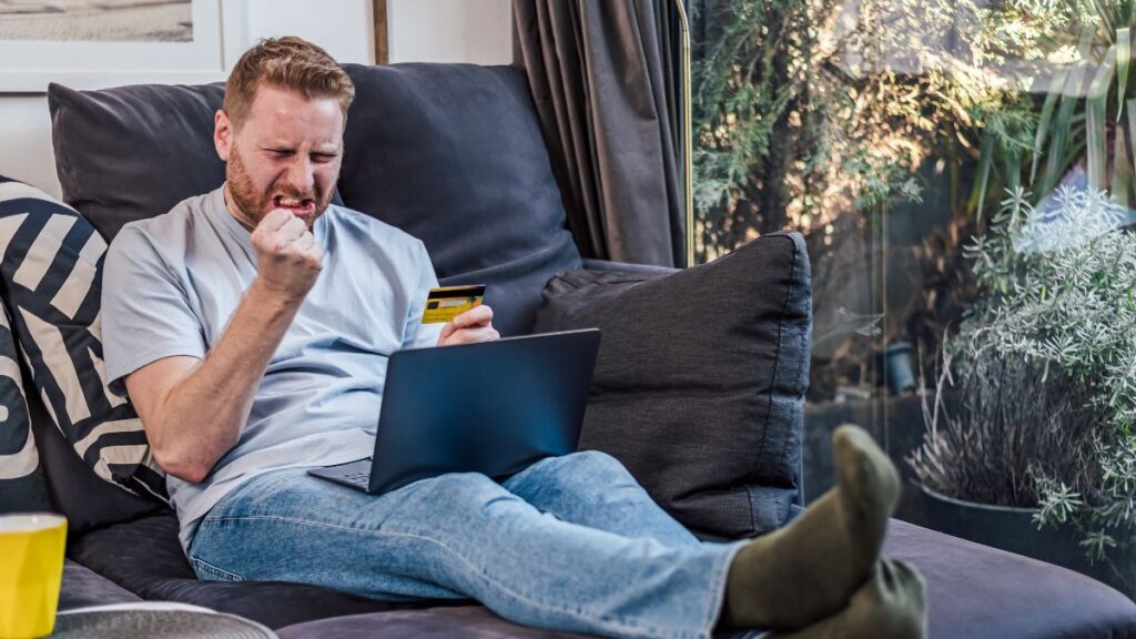 A man upset looking at his laptop