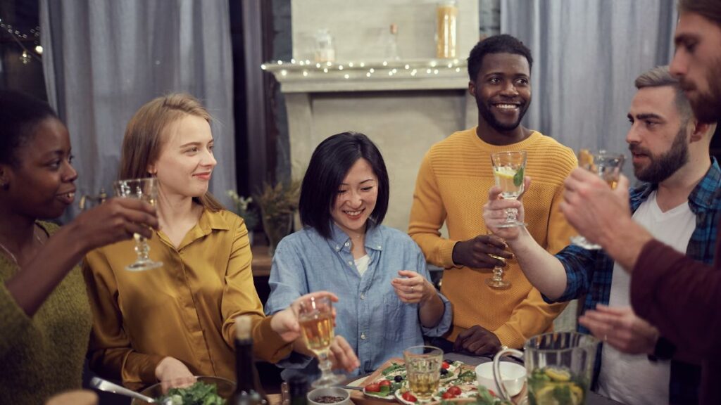 Family having dinner raising glasses