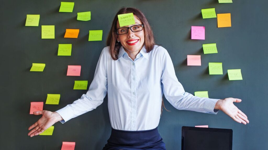 Woman with sticky notes everywhere and one on her head