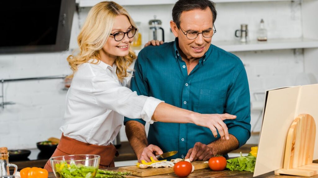 couple cooking from a recipe book