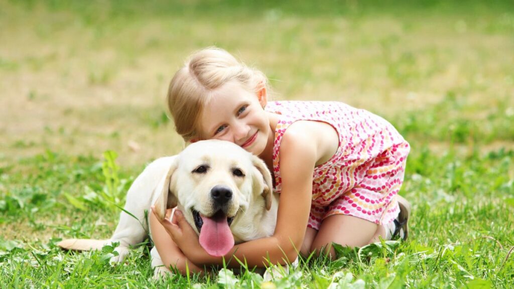 girl with dog in a field