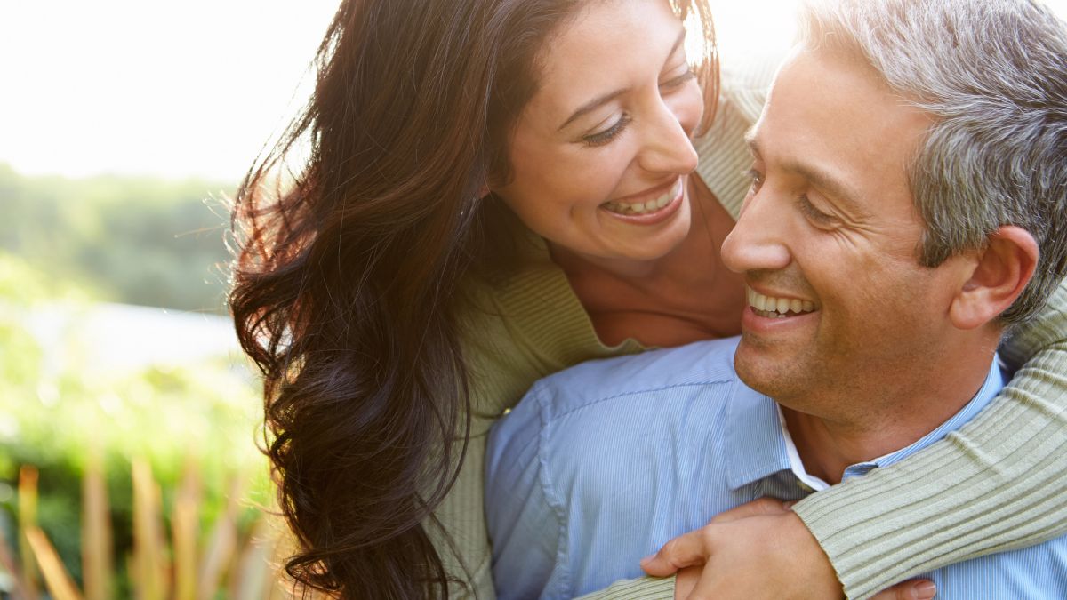 happy couple, woman hugging man from behind