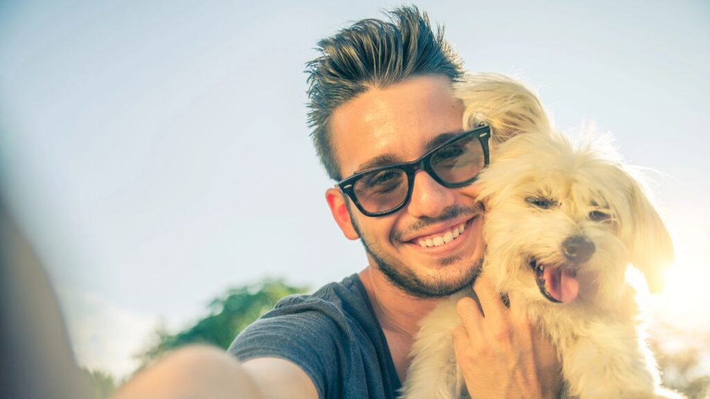 man and dog taking selfie