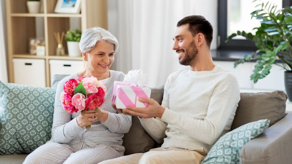 man giving older person a gift