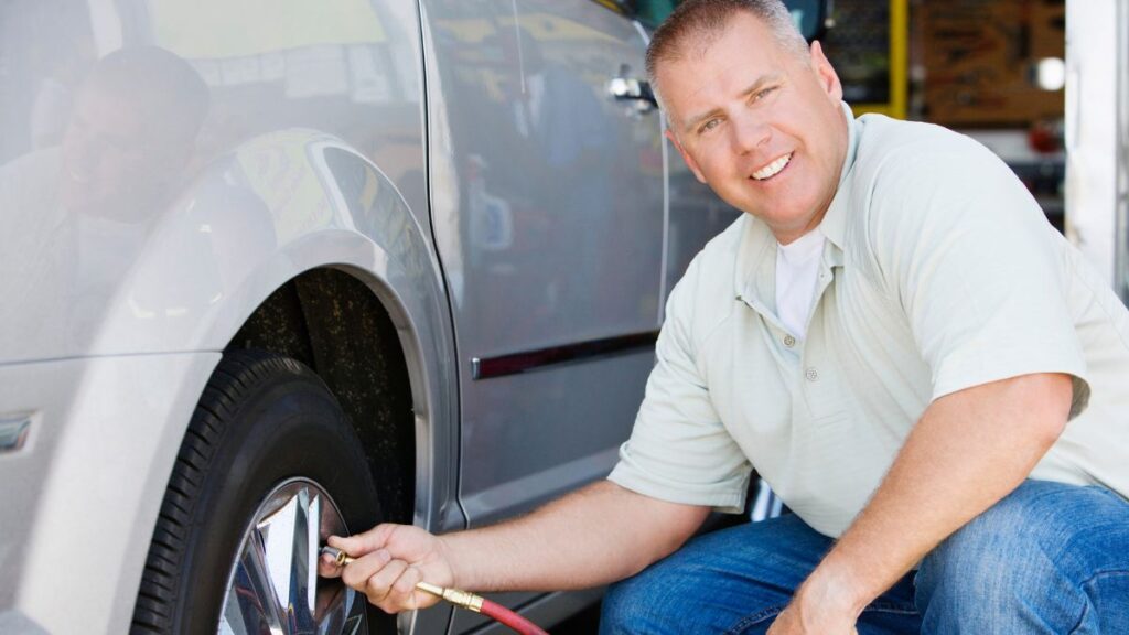 man inflating tire