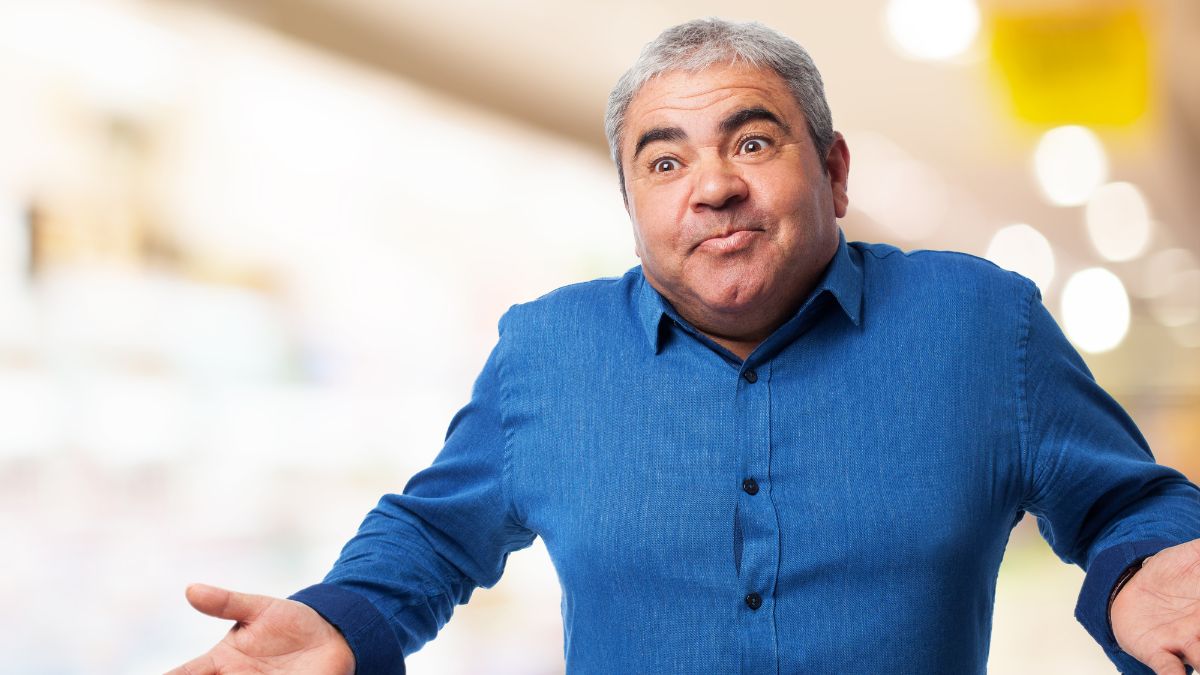 man looking confused with hands up