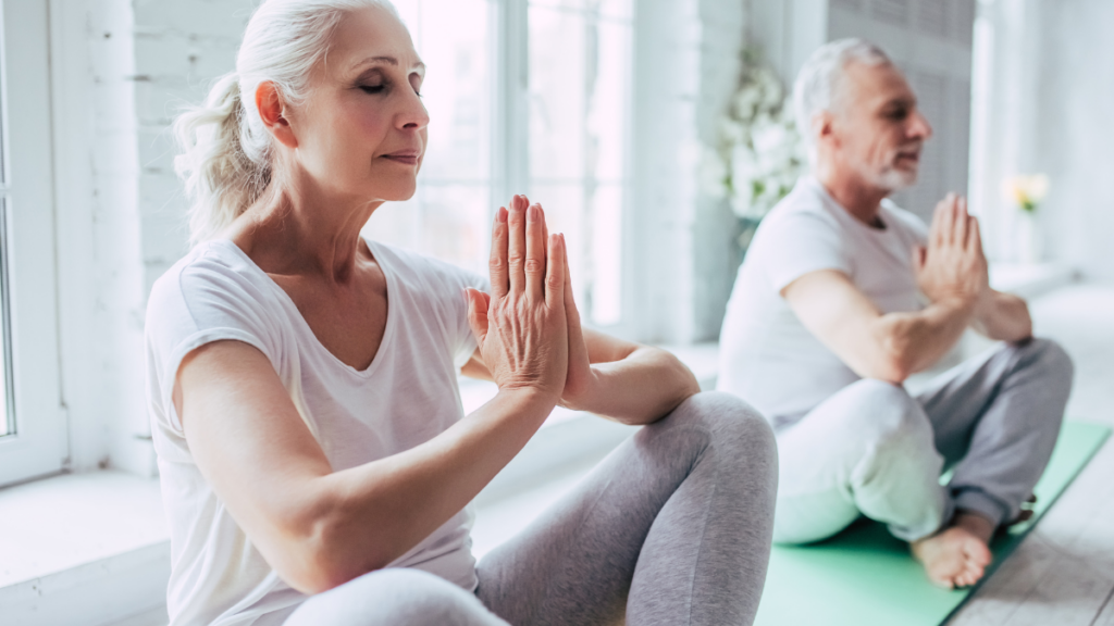 older couple meditating