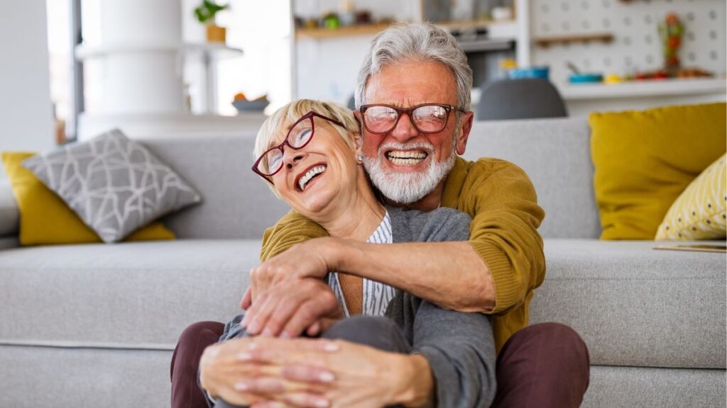 older man and woman cheerful hugging