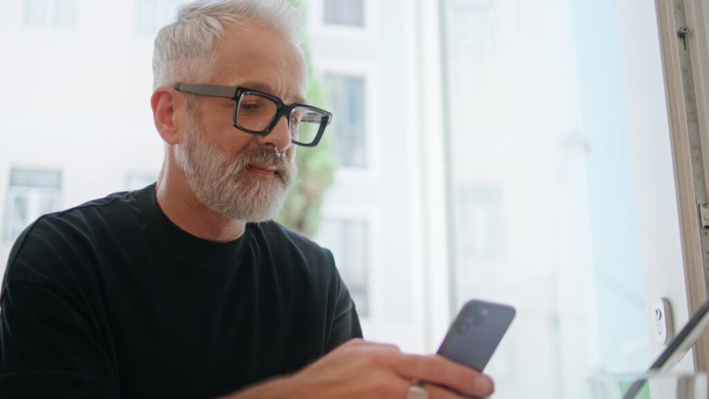 older man looking at his phone