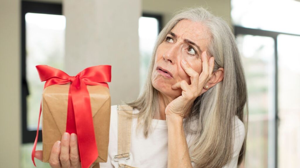 older woman looking confused with gift