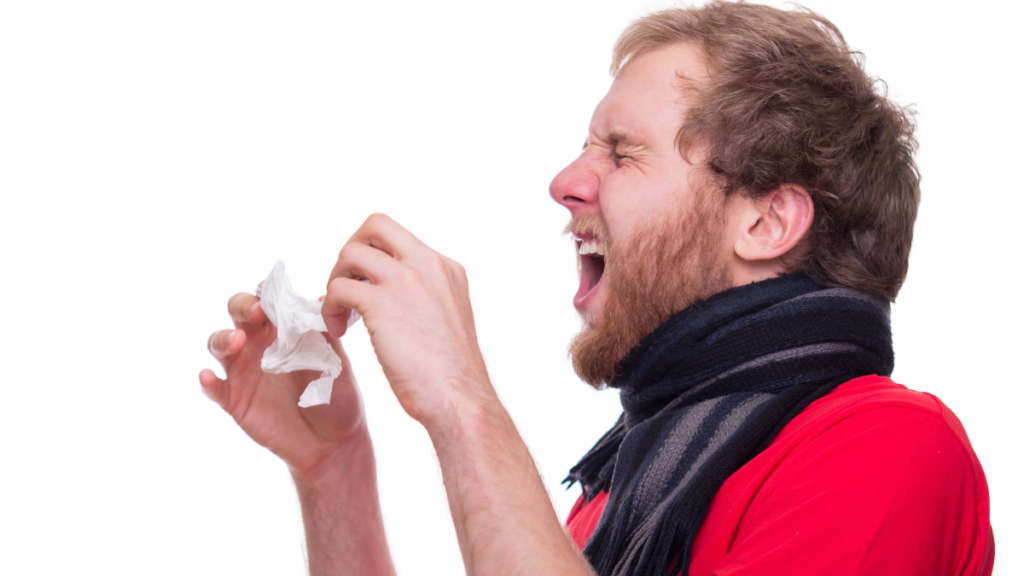 sick man sneezing