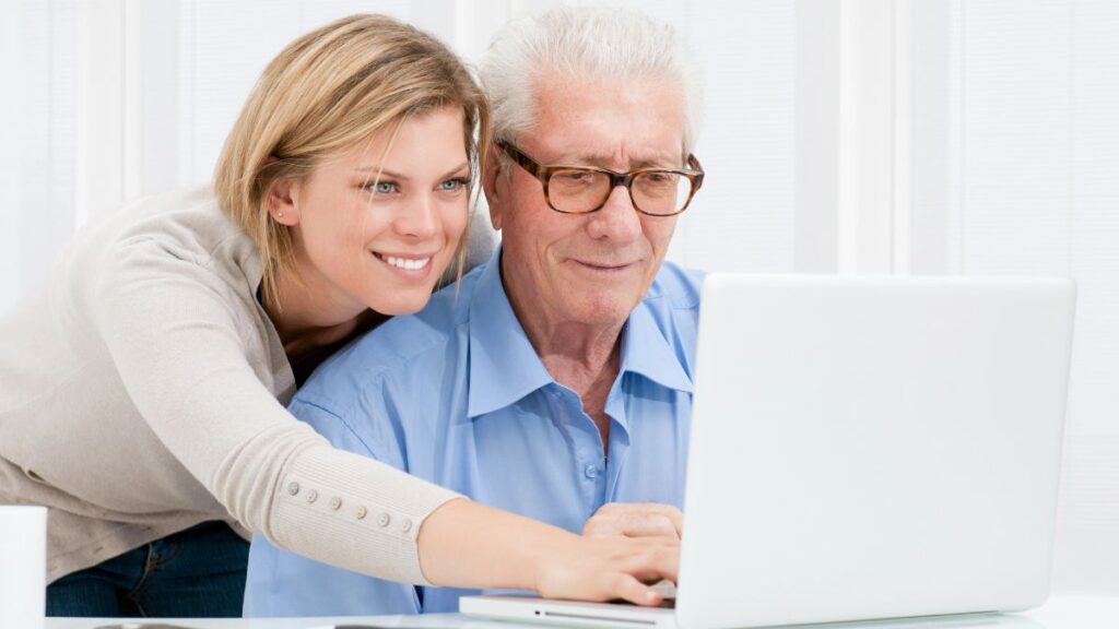 woman and older man on computer