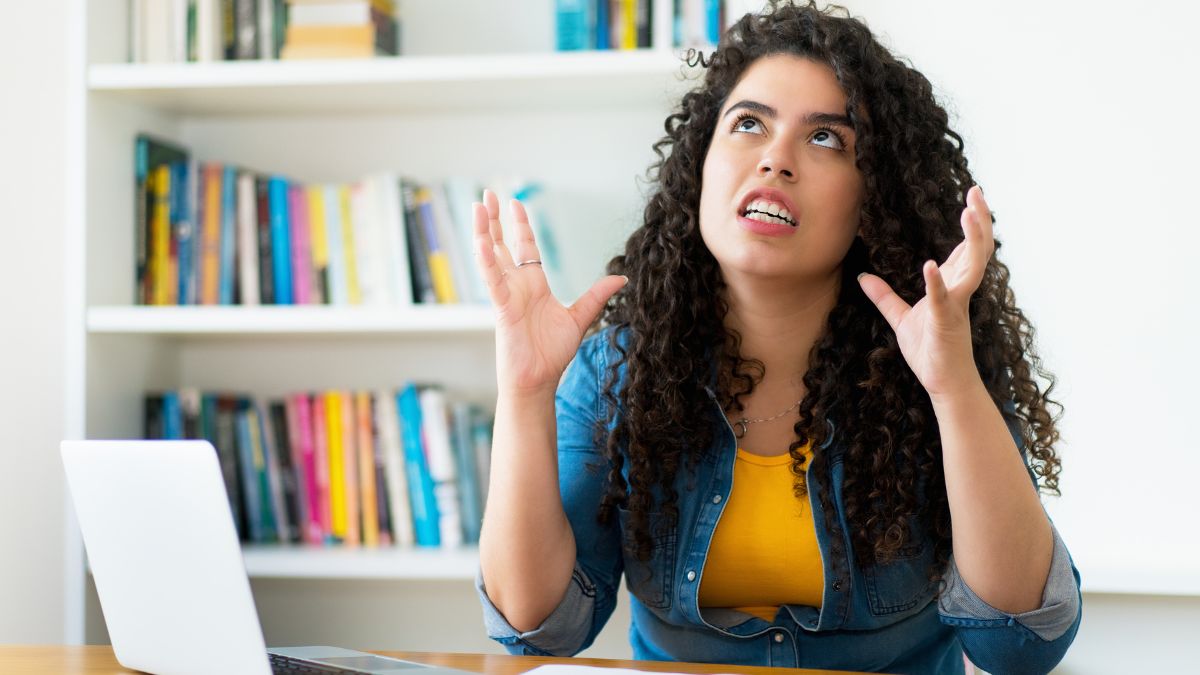 woman looking stressed with hands up