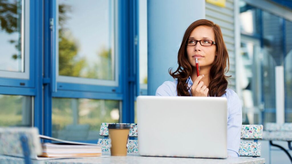 woman sitting and thinking with computer