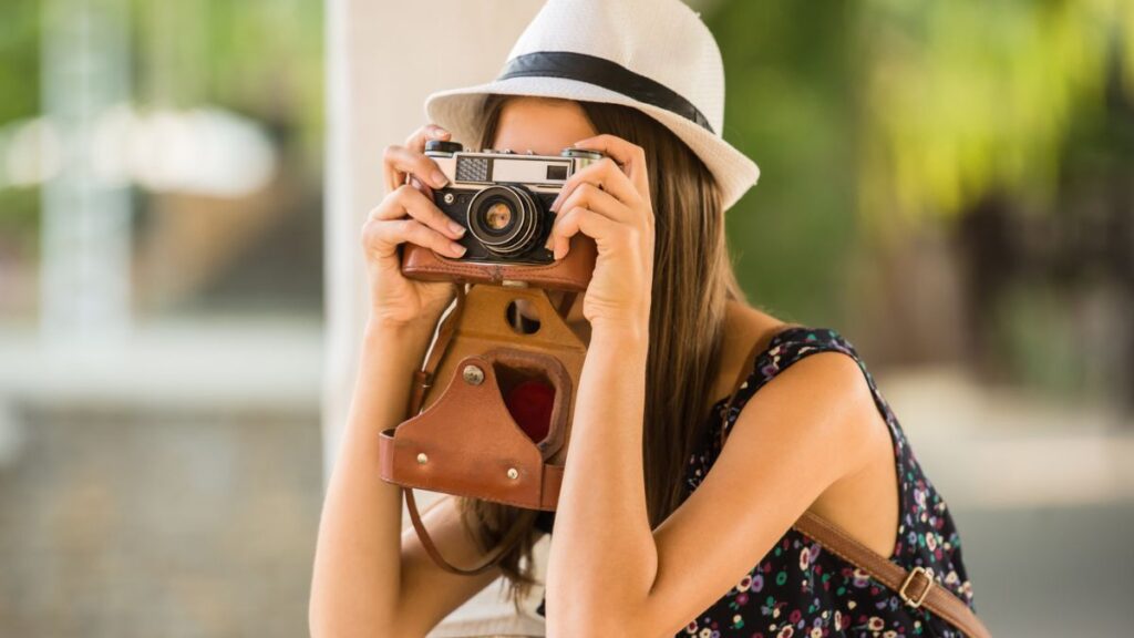 woman taking a picture with an old camera