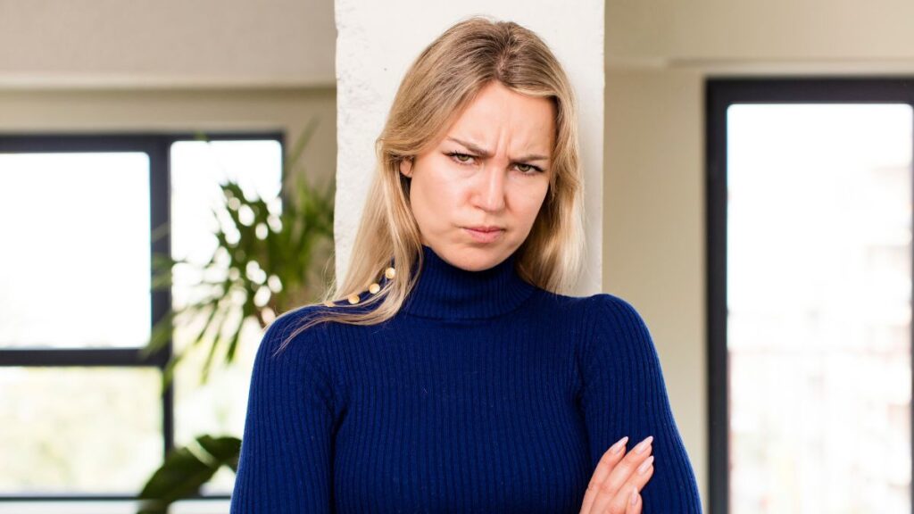 woman with arms crossed looking irritated