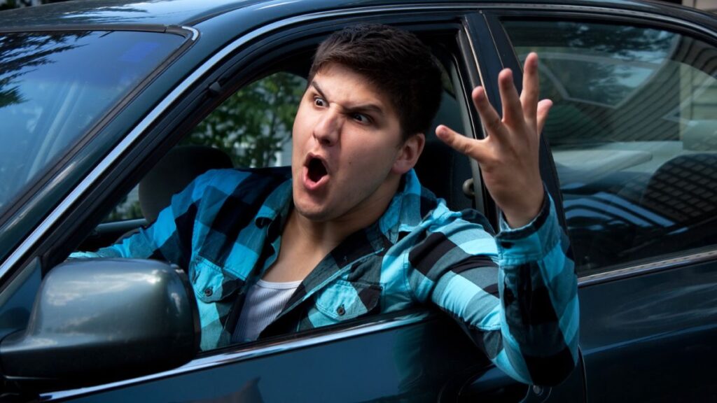 Angry man yelling out the car window