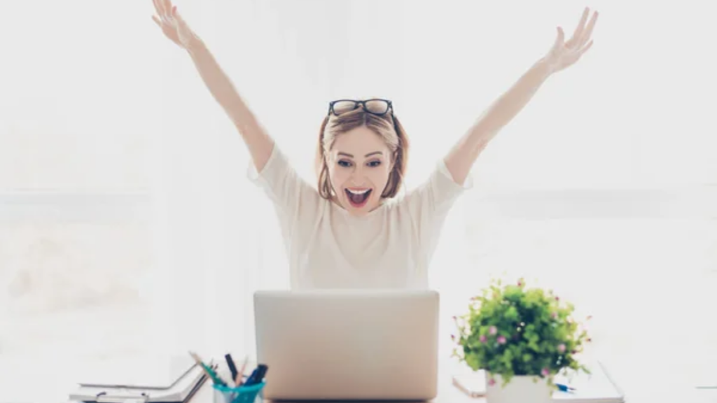 Excited Woman Computer Image Credit: Depositphotos/deagreez1.