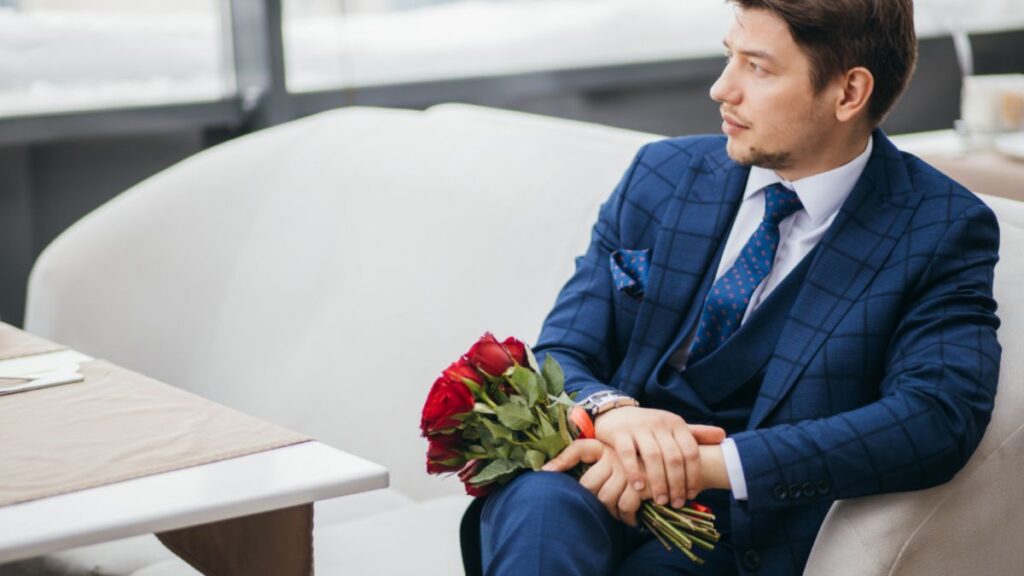 Man sitting on the couch with flowers