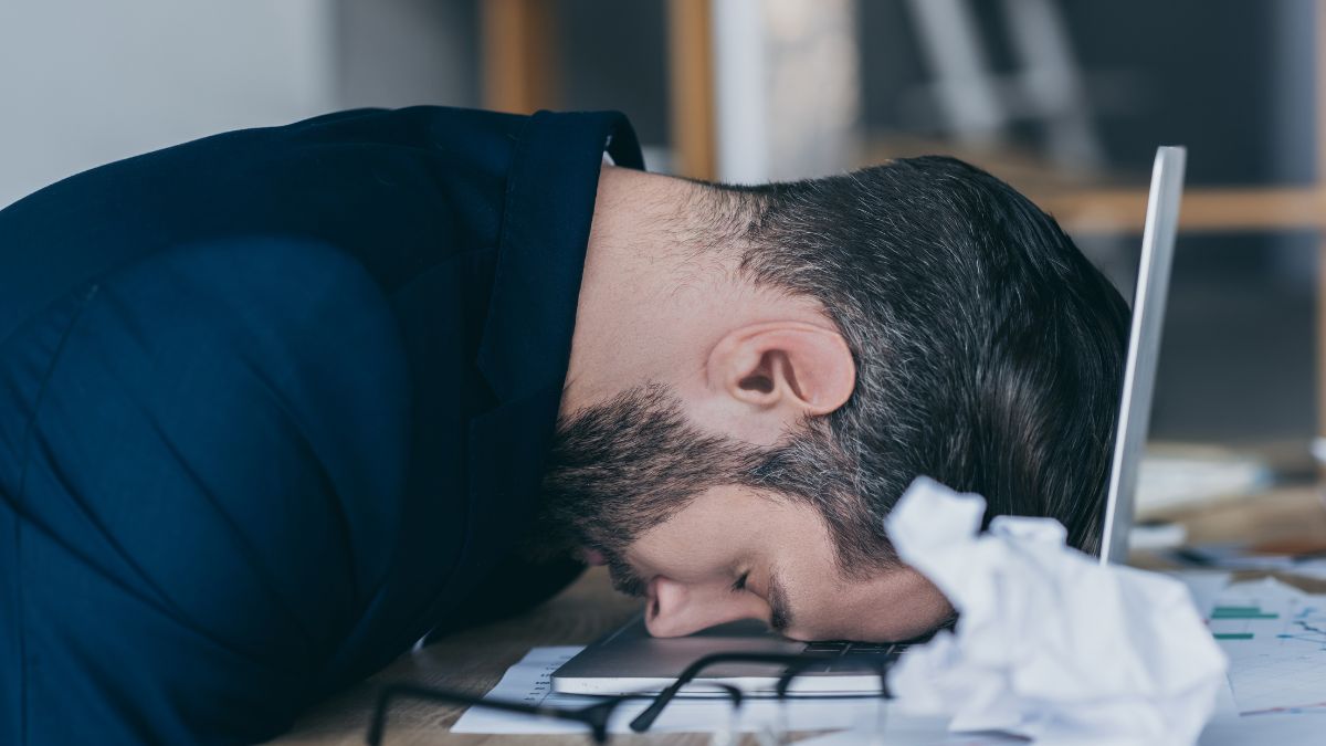 Man with his head on his laptop