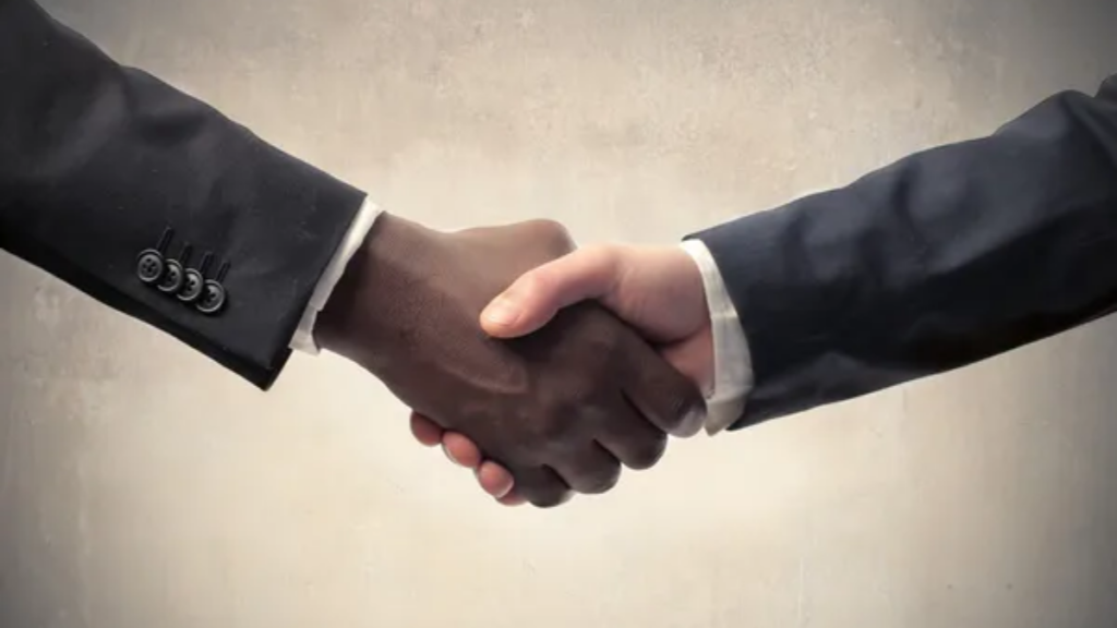 Multicultural Hand Shake Men Image Credit: Depositphotos/olly18.