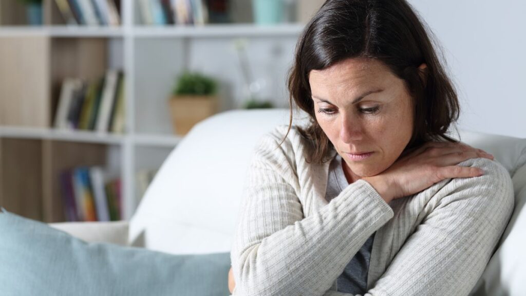 Woman looking upset on the couch with anxiety