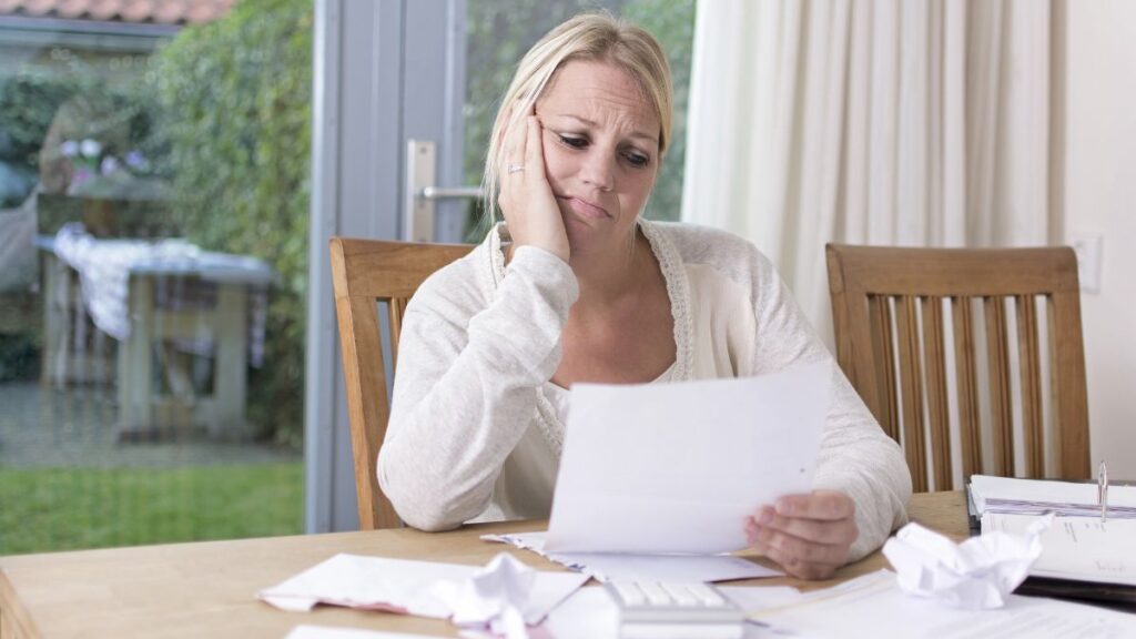 Woman upset looking at bills