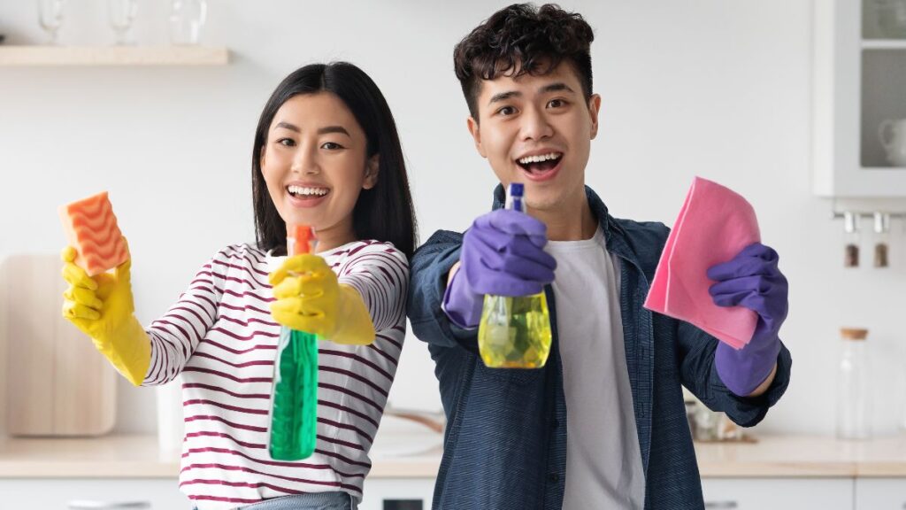 couple excited with cleaning supplies