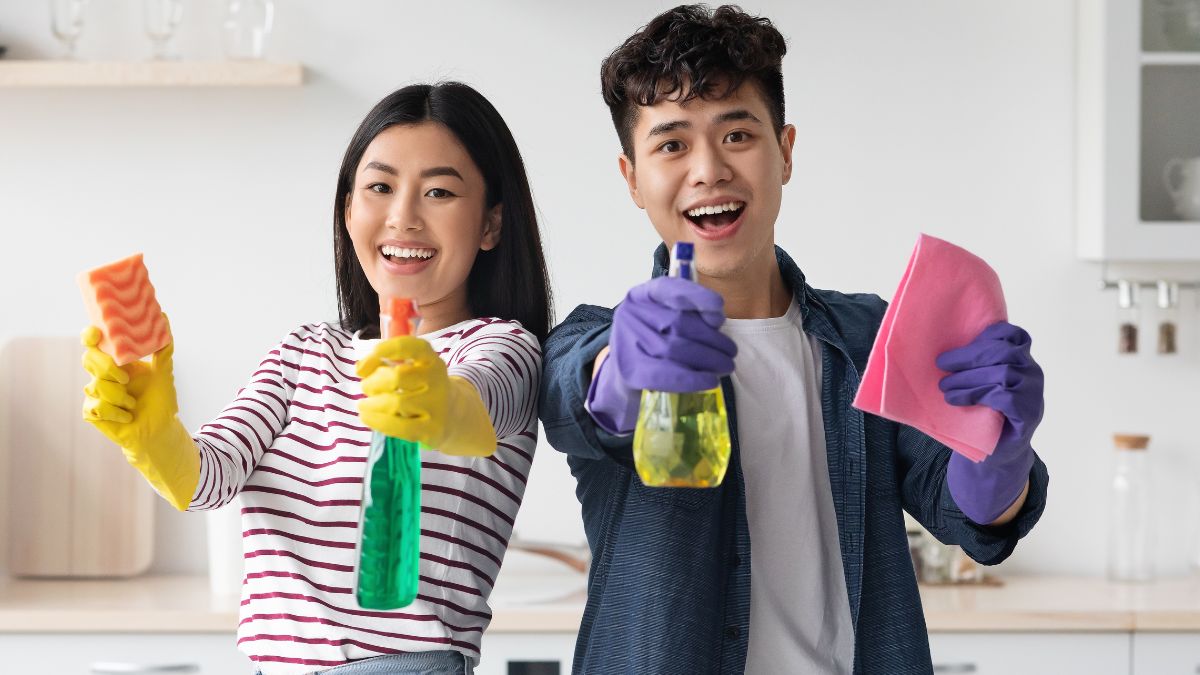 couple excited with cleaning supplies