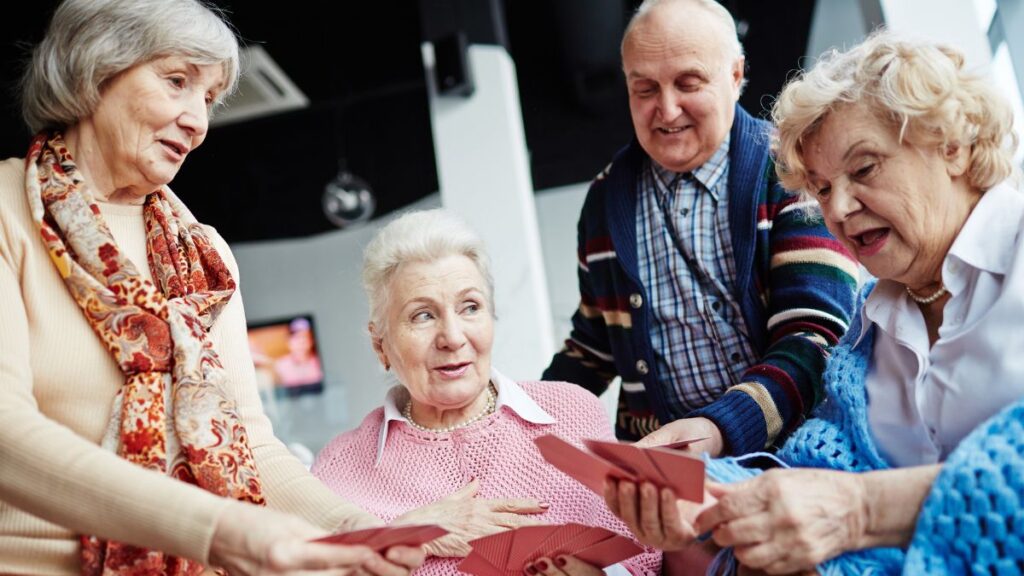 elderly friends playing cards