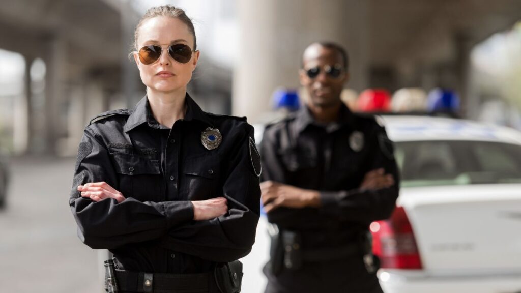 female police officer talking and a male officer behind her