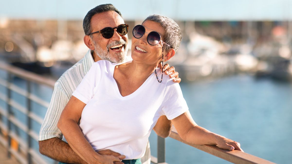 happy older couple by the water