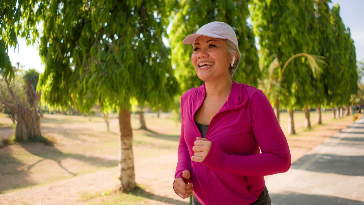 happy woman running in the park