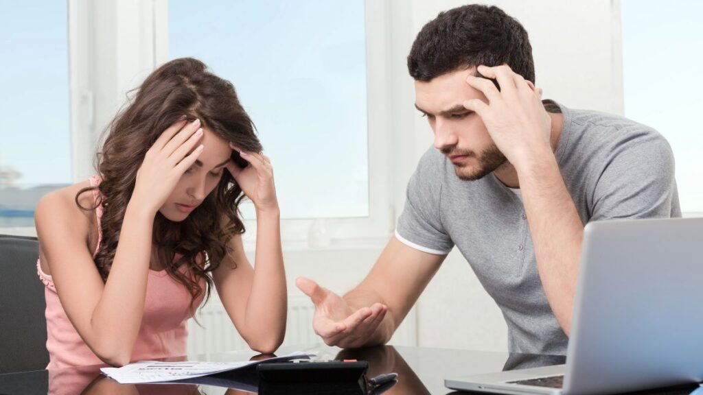 man and woman stressed over bills