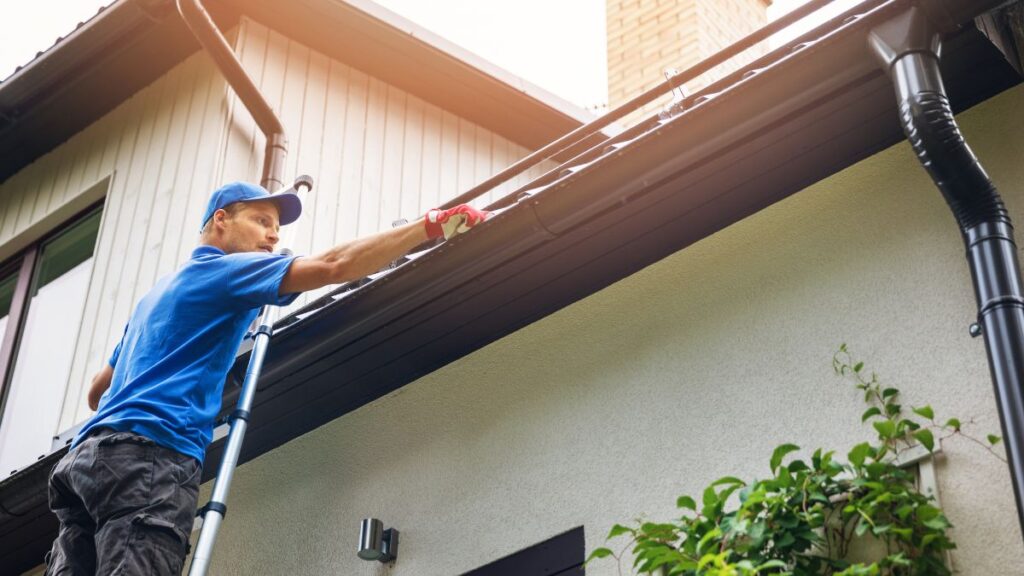 man-cleaning-gutters