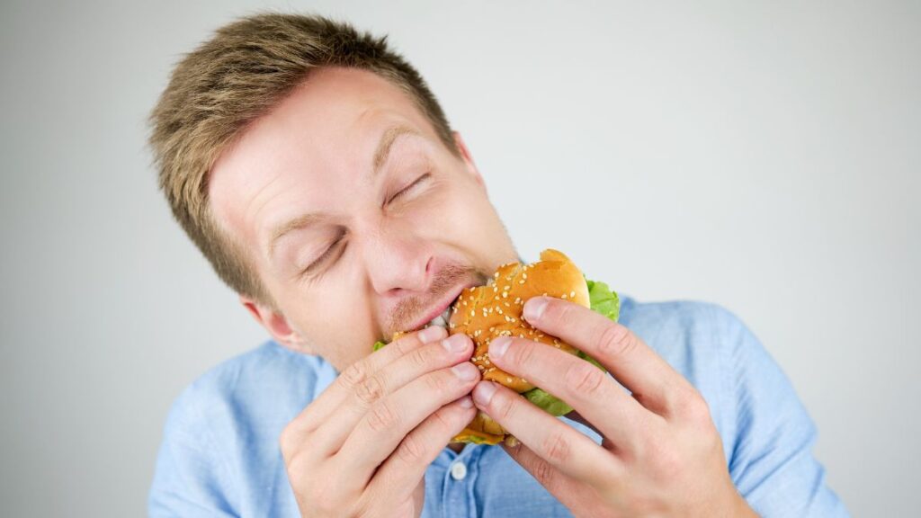 man eating a hamburger