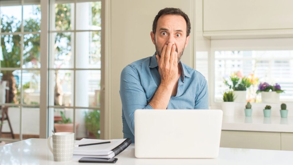 man looking surprised with computer