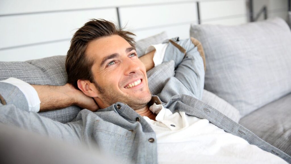 man relaxing on couch