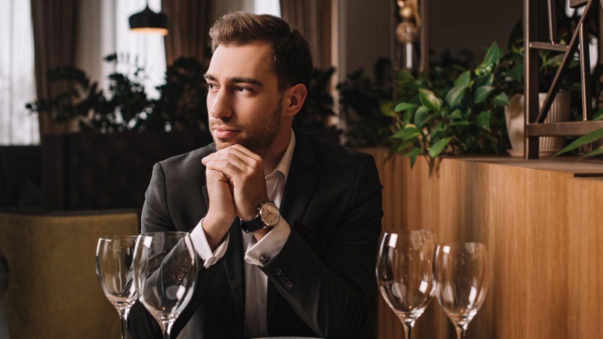 man sitting at able waiting for date