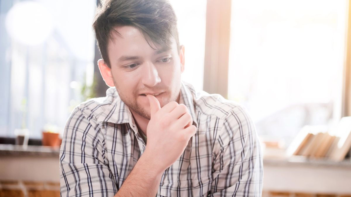 man thinking at table