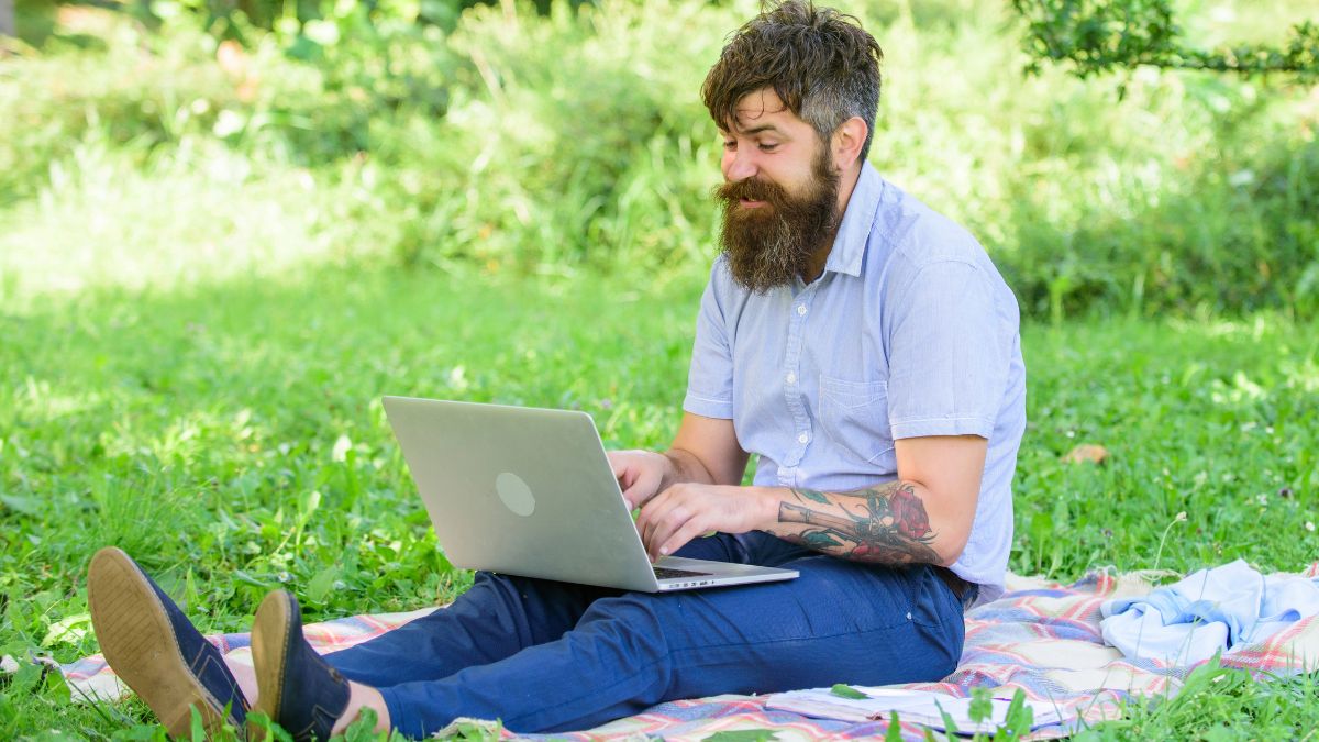 man typing outside