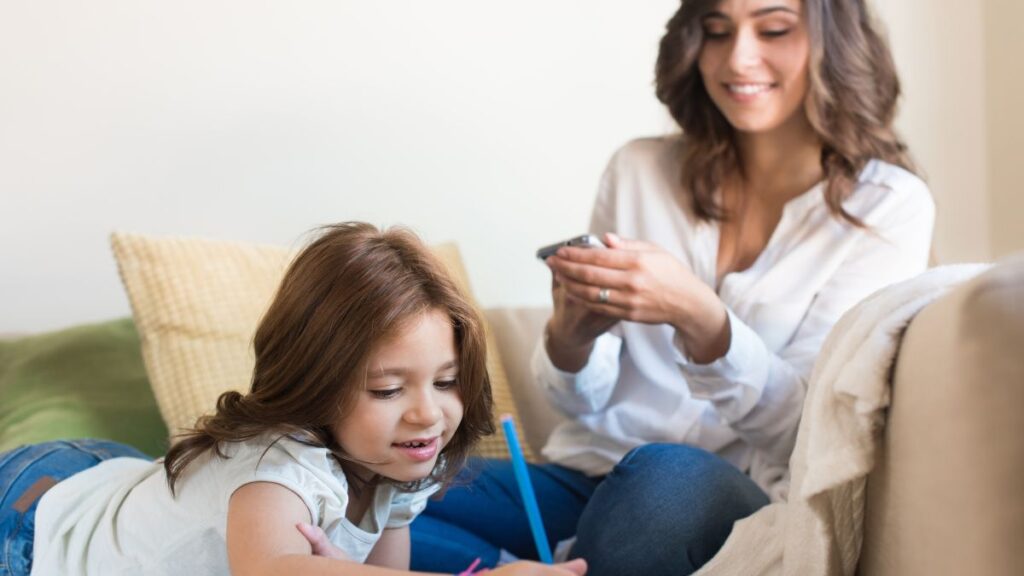 mother with daughter writing