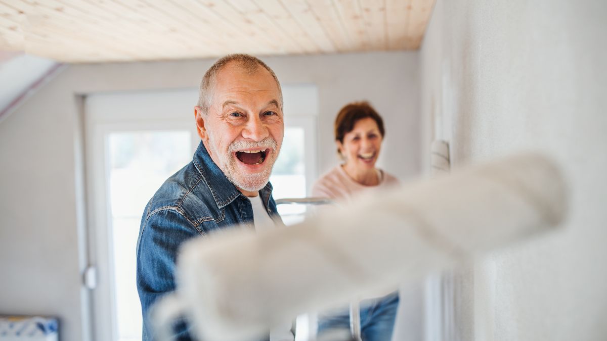 older couple painting and laughing