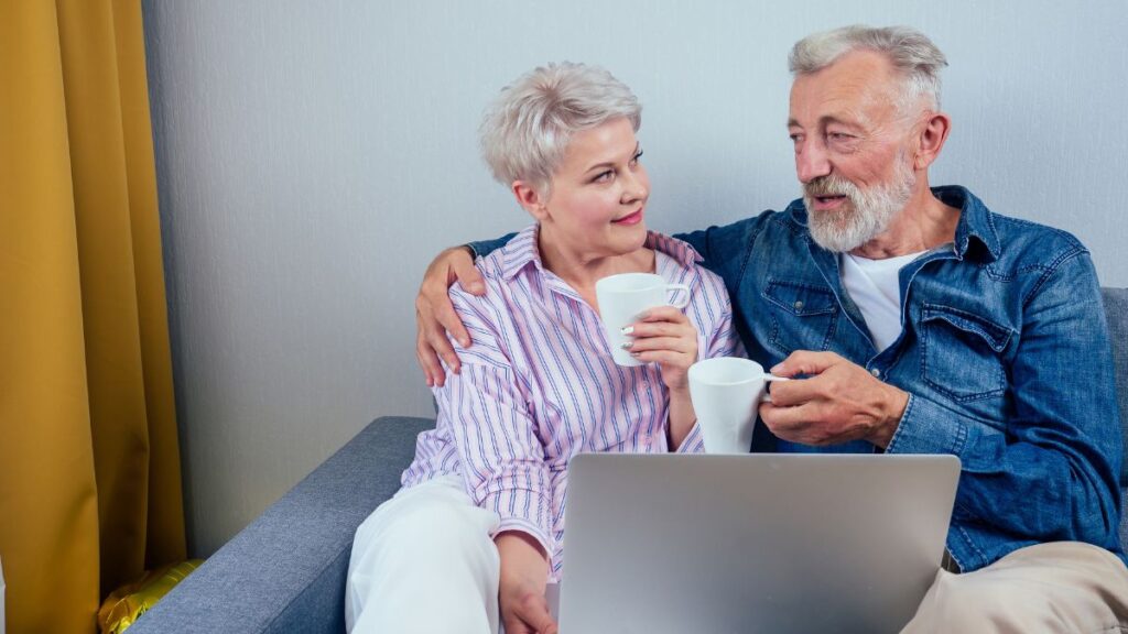 older couple sitting together with computer