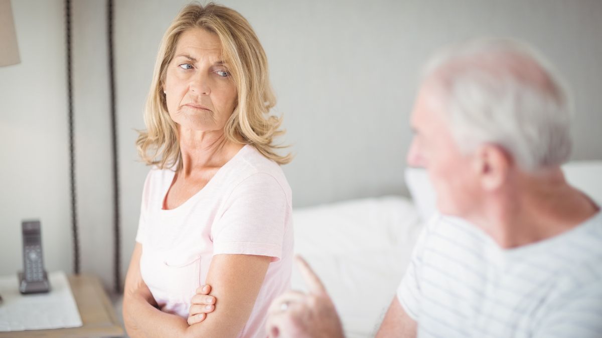 upset couple sitting on the bed